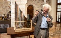 A man inspects a piece of the functioning replica from the oldest organ in Christendom, during the instrument's unveiling at the Saint Saviour's Monastery in the old city of Jerusalem