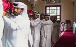 Pallbearers carry the shrouded bodies of the dead inside Doha's Sheikh Mohammed bin Abdul Wahhab Mosque in this Qatar TV image.