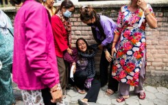 Relatives of victims waited outside a hospital in Kathmandu to receive their bodies