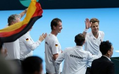 Germany's Yannick Hanfmann (top R) celebrates with teammates after his victory over Japan's Shintaro Mochizuki in Davis Cup second round qualifiers