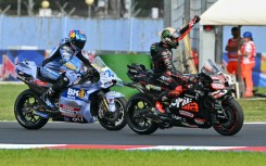 Aprilia Racing team's Italian MotoGP rider Marco Bezzecchi (R) celebrates after winning the San Marino Moto GP Sprint Race