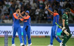 Pakistan captain Salman Agha (R) walks back to the pavilion after his dismissal by Axar Patel (L)