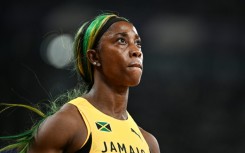 Shelly-Ann Fraser-Pryce glances at the giant screen in Tokyo after bringing down the curtain on her individual sprint career