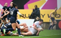 England prop Kelsey Clifford tumbles over the line to score a try during a 40-18 Women's Rugby World Cup quarter-final win over Scotland in Bristol