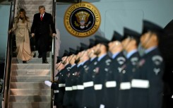 US President Donald Trump and US First Lady Melania Trump disembark from Air Force One at the start of the state visit