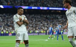 Kylian Mbappe celebrates his second penalty as Real Madrid came from behind to beat Marseille 2-1