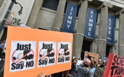 Demonstrators hold signs as they rally to protest the cancelation of the "Jimmy Kimmel Live!" show outside the El Capitan Entertainment Centre on Hollywood Boulevard, from where the show is broadcast in Hollywood, California