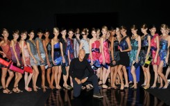 The death of legendary Italian designer Giorgio Armani (C), seen here at 2009's Milan Fashion Week, will overshadow this year's event