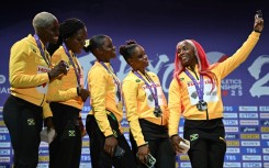 Leader of the pack: Shelly-Ann Fraser-Pryce takes one last picture with her sprint relay teammates