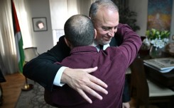 Husam Zomlot embraces a member of staff after Britain's Prime Minister Keir Starmer formally recognised a Palestinian state