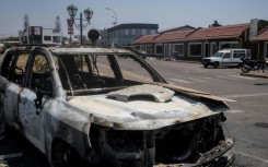 The protest left burnt-out cars strewn across the streets of Madagascar's capital