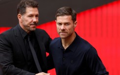 Real Madrid's Spanish coach Xabi Alonso (R) admitted his team deserved to lose the derby clash against Atletico Madrid led by Diego Simeone (L)