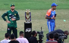 India captain Suryakumar Yadav (R) and Pakistani counterpart Salman Agha ignore each other at the toss ahead of the Asia Cup final in Dubai on Sunday