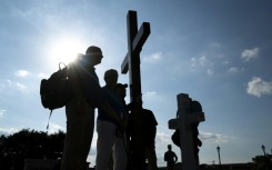 People gather outside an interfaith service at the Basilica of Saint Mary in Minneapolis, Minnesota, following a mass shooting at a local Catholic school in August 2025