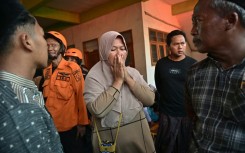 Relatives of missing students gather as search and rescue operations continue at a boarding school in East Java