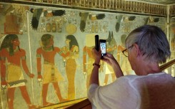 A tourist visits the tomb of Pharaoh Amenhotep III in the Valley of the Kings after the site was opened to the public