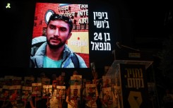 A picture of Nepalese national Bipin Joshi held hostage by Palestinian militants in Gaza since 2023, is displayed on a screen during a demonstration organised by the families of hostages calling for action to secure their release in Tel Aviv on August 16, 2025
