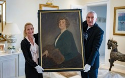 The long-lost oil painting of Madam Kitty Schmidt, shown by authors Urs Brunner and Julia Schrammel
