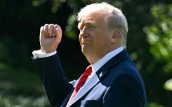 US President Donald Trump gestures as he walks to Marine One on the South Lawn of the White House in Washington, DC, on October 10, 2025, on his way to Walter Reed National Military Medical Center to receive a medical checkup.