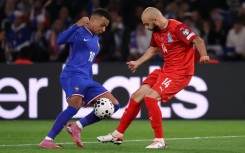 France forward Kylian Mbappe (L) and Azerbaijan defender Elvin Badalov (R) fight for the ball during the FIFA World Cup 2026 Group D qualifier at the Parc des Princes
