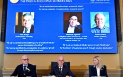 Members of the Swedish Academy of Sciences announce the Nobel economics prize winners, including Peter Howitt (R)