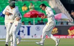Pakistan's Noman Ali (R) celebrates after taking the wicket of South Africa's captain Aiden Markram