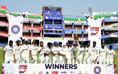 India's players celebrate with the trophy after their win against West Indies