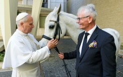 A picture released by the Vatican on Wednesday showing Pope Leo XIV receiving Proton, a purebred Arabian horse