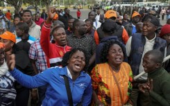 Supporters and mourners of Kenyan opposition leader Raila Odinga react at the Jomo Kenyatta International Airport (JKIA) in Nairobi