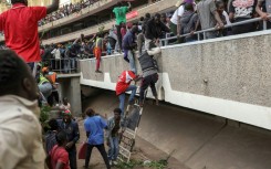 Kenyans fled when security forces fired into the stadium where they gathered to view Odinga's coffin