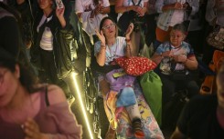 Catholics gather at La Candelaria Square to attend the canonization ceremony of Venezuelan doctor Jose Gregorio Hernandez and Venezuelan Sister Maria Rendiles in Caracas