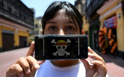 Peruvian law graduate Rosalinda,26, of the Gen Z movement, shows the "One Piece" manga flag on her mobile phone, signifying a demand for deep reforms amid growing insecurity and a decade of political instability