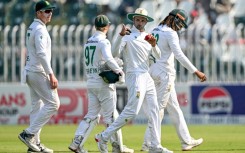 South Africa's Keshav Maharaj (C) gestures as he celebrates after taking his seventh wicket