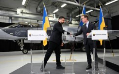 Ukrainian President Volodymyr Zelensky signs a letter of intent with Swedish Prime Minister Ulf Kristersson to get 150 Gripen fighter jets
