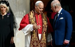 Pope Leo XIV shakes hands with Britain's King Charles III and Queen Camilla in San Damaso courtyard during their state visit to the Vatican