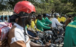 Lorries, buses and motorbikes packed with supporters weaved through town to see the leader