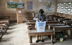 A voter casting his ballot at a polling station in Abidjan