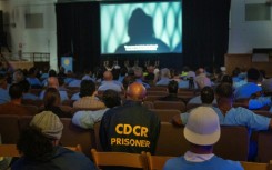 Inmates and guests watch a screening during the San Quentin Film Festival at the infamous California prison