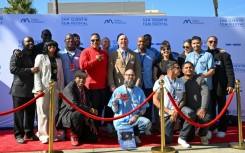 Prison warden Chance Andes (top C) poses on the red carpet with guests and inmates during the San Quentin Film Festival