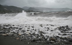 Waves crash onto the beach in Kingston on October 27, 2025; Hurricane Melissa threatened Jamaica with potentially deadly rains after rapidly intensifying into a top-level Category 5 storm
