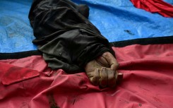 The hand of a dead man is seen among a line of bodies on Sao Lucas Square of the Vila Cruzeiro favela at the Penha complex in Rio de Janeiro, Brazil, on October 29, 2025, in the aftermath of Operacao Contencao (Operation Containment). Residents of a favela in Rio de Janeiro lined up more than 50 bodies at a plaza in their low-income neighborhood on Ocotber 29, a day after the bloodiest police operation in the city's history, AFP reported.