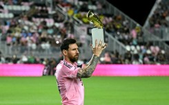 Lionel Messi poses with the MLS Golden Boot trophy after scoring 29 times in 28 games in the regular season