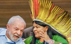 Brazilian President Luiz Inacio Lula da Silva (L) and his Minister of Indigenous Peoples, Sonia Guajajara, chat during a meeting in Belem
