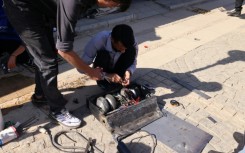 Engineering students prepare their robot for a battle event at Iran's Tech Olympics