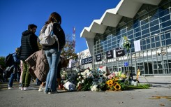 Mourners laid flowers and candles outside the station