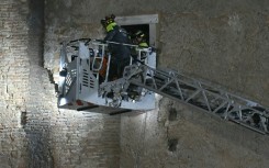 Rescuers worked to evacuate a worker who was trapped in the medieval tower Torre dei Conti after the tower partially collapsed in the historic center of Rome