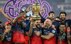 Royal Challengers Bengaluru's Virat Kohli (centre) and teammates celebrate the team's IPL final victory in June this year
