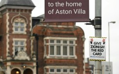 A poster that reads 'Give Zionism the red card' is seen on a lamp post near Villa Park in Birmingham ahead of the Europa League match between Maccabi Tel Aviv and Aston Villa