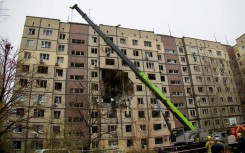 Ukrainian rescuers work at the site of a heavily damaged residential building following an air attack in Dnipro