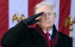 US President Donald Trump salutes at the conclusion of a Veterans Day ceremony at Arlington National Cemetery in Arlington, Virginia on November 11, 2025.